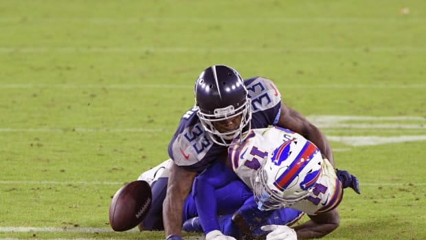 Tennessee Titans cornerback Johnathan Joseph (33) knocks the ball away from Buffalo Bills wide receiver Stefon Diggs (14) during the first half at Nissan Stadium.